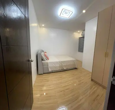 a bedroom with a bed in the middle of a room at 4 Bedroom House for 5-6 guests in Manila