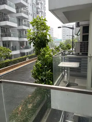 a table on the balcony of a building at Parkside Villas G NEWPORT Philippines in Manila