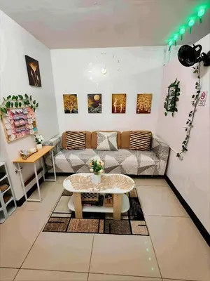 a living room with a couch and a table at Staycation at Brgy Cupang in Manila