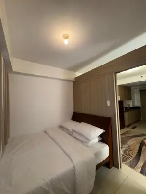 a bedroom with a bed and a large mirror at The Chill Lane- Shore Residences in Manila
