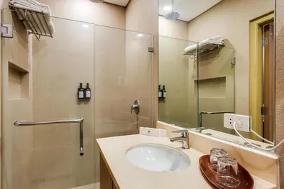 a bathroom with a sink and a mirror at Madison 101 Hotel + Tower in Manila
