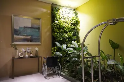 a bathroom with a green wall with plants at Nuvali Sta Rosa Laguna in Pulong Cacawate
