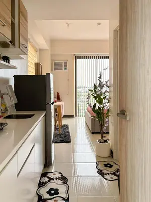 a kitchen with a refrigerator and a plant on the floor at Nuvali Sta Rosa Laguna in Pulong Cacawate