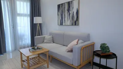 a living room with a couch and a table at Coastal Luxury Residences in Manila