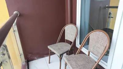 a couple of chairs sitting on a porch at Coastal Luxury Residences in Manila