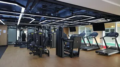 a gym with treadmills and elliptical machines at Coastal Luxury Residences in Manila