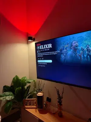 a flat screen tv hanging on a wall at Cami Haus at Fame Residences in Manila