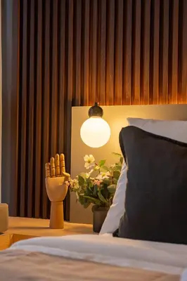 a bedroom with a bed with a lamp and a plant at Amazing View - Cozy 1BR at One Eastwood with Washer High Speed Wi-Fi in Manila