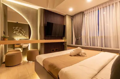 a bedroom with a large bed and a television at Amazing View - Cozy 1BR at One Eastwood with Washer High Speed Wi-Fi in Manila
