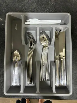 a plastic tray with forks and spoons and forks and knives at Family Condo SMB in Manila