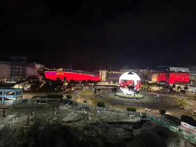 a city at night with a red and white building at Family Condo SMB in Manila