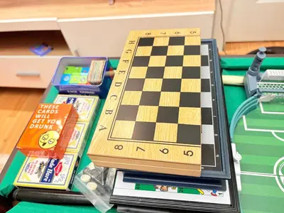 a chess board on top of a table with books at Azure Staycation by Casa Tremora Deluxe in Manila