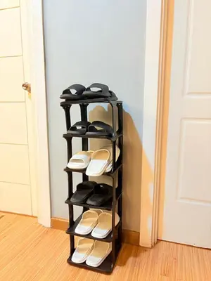 a black shelf with pairs of flip flops at Azure Staycation by Casa Tremora Deluxe in Manila