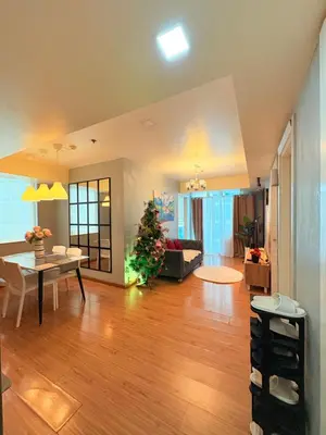 a large living room with a christmas tree in it at Azure Staycation by Casa Tremora Deluxe in Manila