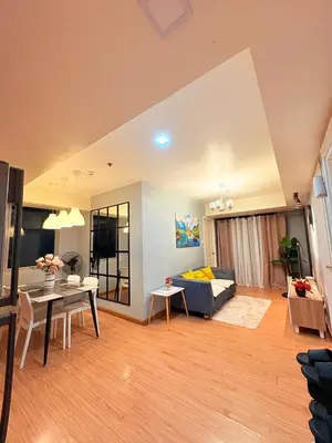 a living room with a couch and a table at Azure Staycation by Casa Tremora Deluxe in Manila