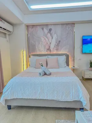 a bedroom with a bed with a teddy bear on it at nJoy! Elegant Peach Heaven at Venice Grand Canal in Manila