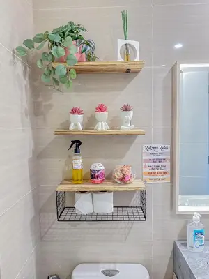 a bathroom with a shelf above a toilet at nJoy! Elegant Peach Heaven at Venice Grand Canal in Manila