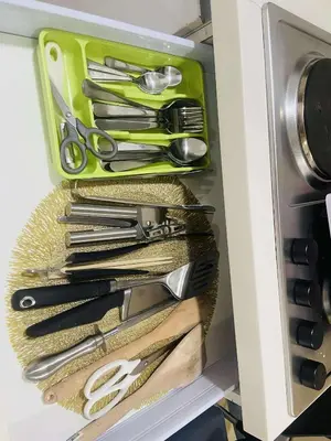 a drawer full of kitchen utensils in a refrigerator at Azure Urban Condomiun Near Airport in Manila