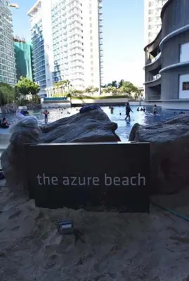 a sign for the arrive beach in a city at Azure Urban Condomiun Near Airport in Manila