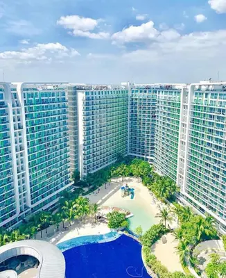 an aerial view of a large building with a pool at Azure Urban Condomiun Near Airport in Manila
