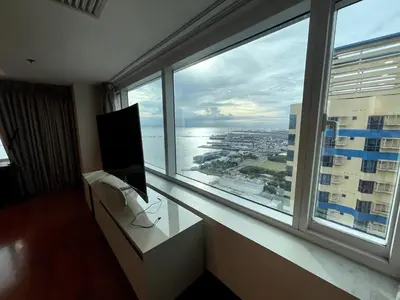 a room with a tv and a large window at Ultra Luxury 5BR Penthouse in Manila Bay Rizal Park in Manila