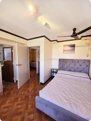 a bedroom with a large bed in a room at Greenhills Garden Square Residences 2BR & 2 Toilets Quezon City in Manila