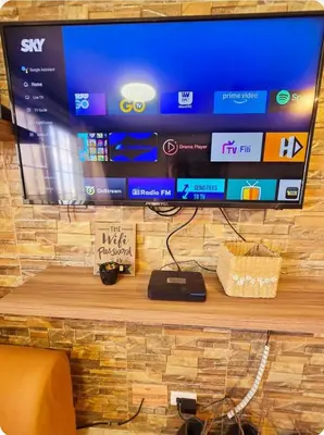 a flat screen tv sitting on top of a wooden table at Greenhills Garden Square Residences 2BR & 2 Toilets Quezon City in Manila