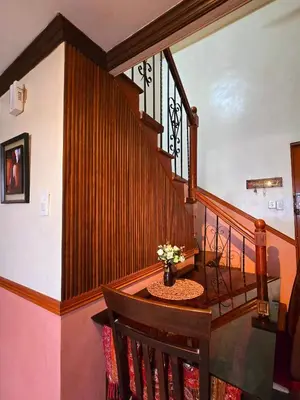a wooden staircase with a vase of flowers on it at Greenhills Garden Square Residences 2BR & 2 Toilets Quezon City in Manila