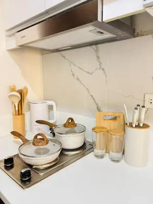 a kitchen counter with pots and pans on a stove at Luxurious Room in Bel Air Makati - Air Residences in Manila