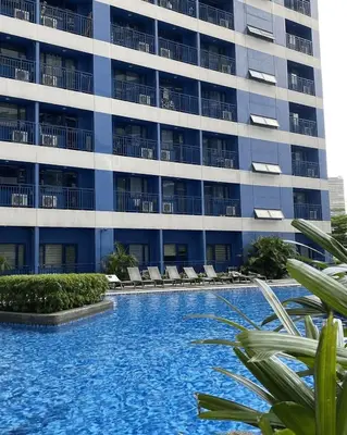a pool in front of a building at Luxurious Room in Bel Air Makati - Air Residences in Manila