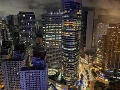 a night view of a city with tall buildings at Luxurious Room in Bel Air Makati - Air Residences in Manila