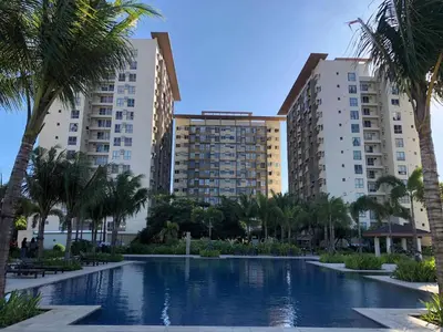 a swimming pool in front of two tall buildings at Staycation in Brgy Cupang in Manila