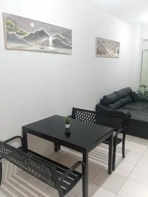 a living room with a black table and a couch at Staycation in Brgy Cupang in Manila