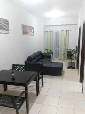 a living room with a couch and a table at Staycation in Brgy Cupang in Manila