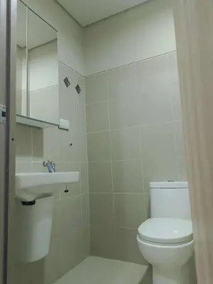 a bathroom with a toilet and a sink at Marhulz Two Bedroom Staycation at S Residences in Manila