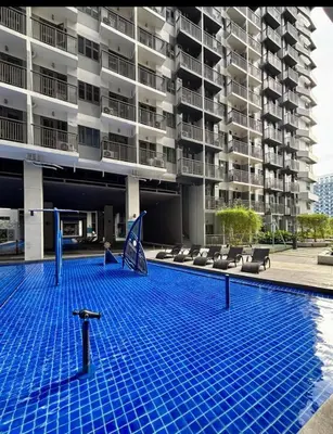 a swimming pool in front of a building at Marhulz Two Bedroom Staycation at S Residences in Manila