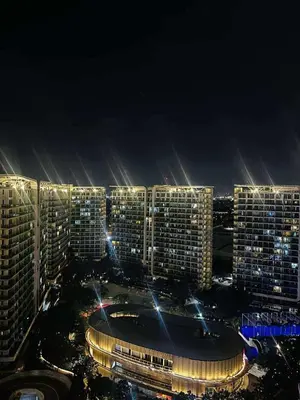 a group of tall buildings at night with lights at Azure Staycation by Cm in Manila