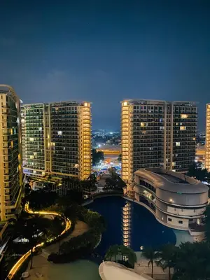 a view of a city at night with tall buildings at Azure Staycation by Cm in Manila