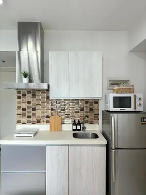 a kitchen with a sink and a microwave at Premium Unit in Maldives in Manila