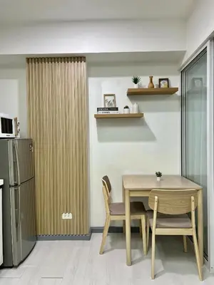 a dining room with a table and a refrigerator at Premium Unit in Maldives in Manila