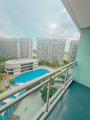 a balcony with a view of a pool and buildings at Premium Unit in Maldives in Manila