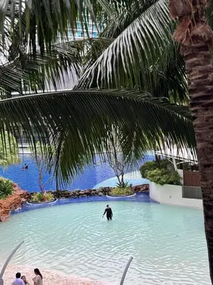 a man riding a surfboard in a pool of water at Premium Unit in Maldives in Manila