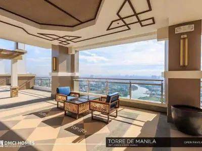 a living room with furniture and a view of the ocean at Torre de Manila Taft Avenue near Luneta Park US Embassy Intramuros Ermita Manila in Manila