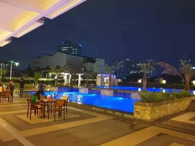 a hotel with a pool at night at Torre de Manila Taft Avenue near Luneta Park US Embassy Intramuros Ermita Manila in Manila