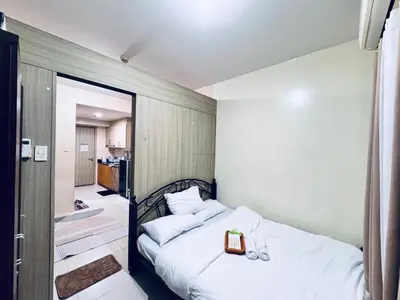 a small bedroom with a bed with a box on it at Smdc Breeze Residences-The Metro Breeze-Staycation in Manila