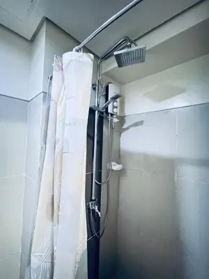a shower in a bathroom with a shower curtain at Smdc Breeze Residences-The Metro Breeze-Staycation in Manila
