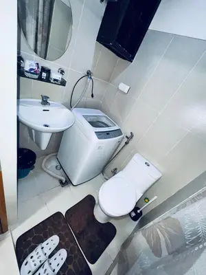 a bathroom with a toilet and a sink at Smdc Breeze Residences-The Metro Breeze-Staycation in Manila