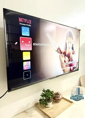 a flat screen tv hanging on a wall at SHORE 2 Residences MALL OF ASIA, NAIA, PICC in Manila