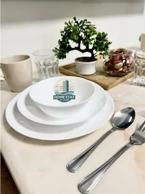 a white plate sitting on top of a table with spoons at SHORE 2 Residences MALL OF ASIA, NAIA, PICC in Manila