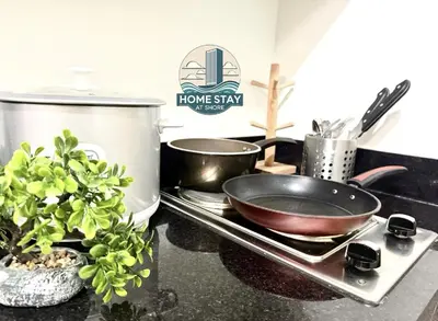 a kitchen counter with a frying pan on a stove at SHORE 2 Residences MALL OF ASIA, NAIA, PICC in Manila